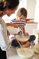 Image showing Mother, milk or kid baking in kitchen as a family with a young kid learning cookies or cake recipe at home. Pastry, cooking or mother baker helping or teaching daughter to bake for child development