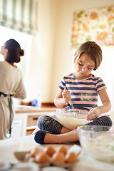 Image showing Mom, mixing or girl child baking in kitchen as a family with kid learning cookies pastry recipe at home. Blur, cooking independence or baker helping or teaching child to bake for skills development