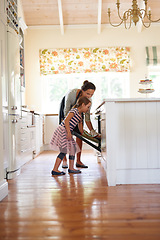 Image showing Mother, oven or kid baking in kitchen as a happy family with a young girl learning cookies recipe at home. Cake, girl baker or mom helping or teaching daughter to bake in stove for child development