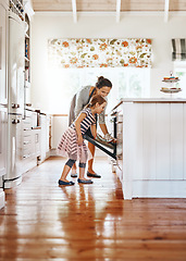 Image showing Food, mother with her child baking and in the kitchen of their home with a lens flare. Happy family or bonding time, bake or cook and woman with girl at the oven prepare a meal for lunch together