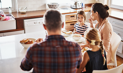 Image showing Happy family, morning and breakfast on kitchen table for meal, eating or bonding time together at home. Mother, father and children with healthy food to start the day for nutrition or cereal in house