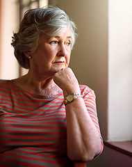 Image showing Senior woman, sad and thinking at window for memory, ideas and home on living room sofa. Elderly lady, remember and worry with decision, mental health and retirement on lounge chair, fear and anxiety