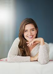 Image showing Smile, portrait and woman relax on sofa in home living room on holiday. Face, happy and young female person from Canada on couch in lounge, apartment or house to enjoy mockup space and lens flare.