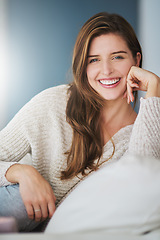 Image showing Portrait, smile and woman relax on sofa in home living room on holiday. Face, happy or young female person from Canada on couch in lounge, apartment or house to enjoy me time, vacation or break alone