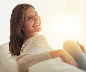 Image showing Happy, portrait and woman relax on couch in home living room for easy lifestyle. Face, smile and young person from Canada on sofa in lounge, apartment or house to enjoy break, mockup and lens flare.