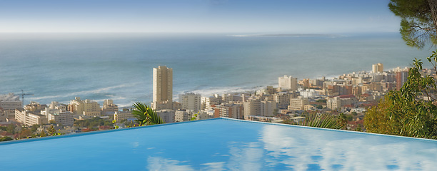 Image showing Travel, ocean and infinity pool in city on vacation and hotel view in Cape Town with nobody, buildings and urban beach property. Cityscape, sea and sky at luxury accommodation for summer holiday trip