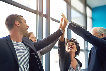 Image showing Business people, group high five and happy in office with teamwork, smile and support for company goals. Men, women and hands in air for team building, achievement and celebration at insurance agency