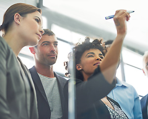 Image showing Woman, writing and glass with business people in group for strategy, planning and collaboration in office. Female leader, pen and brainstorming with teamwork, ideas and notes for goal with diversity