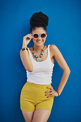 Image showing Fashion, portrait and woman with sunglasses on blue background, wall and summer streetwear, trendy clothes or shades mockup. Girl, happy and excited model with cool style, vision and urban mock up