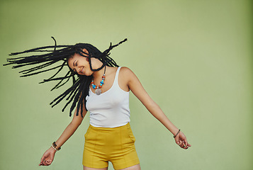 Image showing Happy, dance and freedom with black woman in studio for energy, natural and hip hop. Happiness, talent and culture with african female dancer on green background for mockup, motivation and crazy