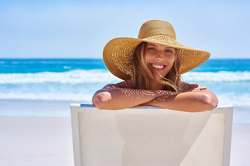 Image showing Portrait, beach and woman on a holiday, summer and travel with happiness, relax and getaway with tourism. Face, female person or girl on a chair, seaside vacation and tropical island with destination