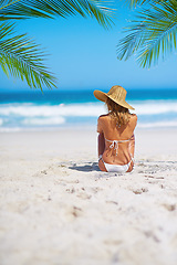 Image showing Tropical, island and back of woman on beach sand for adventure, holiday and vacation in Mauritius. Travel mockup, ocean and female person relax in bikini for paradise, tourism and summer getaway