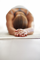 Image showing Woman, hands and stretching body in yoga on floor mat for spiritual wellness, exercise or zen workout at home. Female person or yogi in warm up stretch for fitness or mental health on mockup space