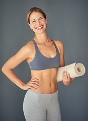 Image showing Happy woman, fitness and yoga mat for exercise, zen workout or healthy body against a grey studio background. Portrait of female person yogi with smile and mat for spiritual wellness or mental health