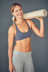 Image showing Happy woman, portrait smile and yoga mat for zen workout, exercise or healthy body against a grey studio background. Female person or yogi smiling for spiritual wellness, fitness and mental health