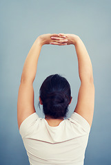 Image showing Woman, work and stretching arms on studio, blue background or tired body from working, bad posture or strain. Stretch, arm and hands or businesswoman focus on care of back pain and stress management