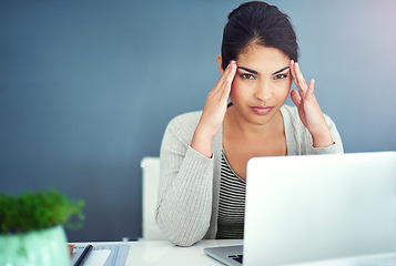 Image showing Business woman, headache and laptop in office with hands, portrait and anxiety at desk at startup. Young businesswoman, burnout and pain with fatigue, frustrated and stress for glitch in workplace