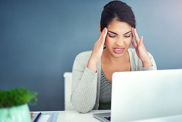 Image showing Business woman, stress headache and laptop in office with hands, mistake and anxiety at desk at startup. Young businesswoman, burnout and pain with fatigue, frustrated and glitch on pc in workplace