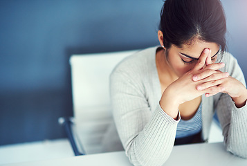 Image showing Business woman, stress and tired in office with hands, worried and anxiety at desk at startup. Young businesswoman, burnout and headache with anxiety, frustrated or financial crisis in workplace