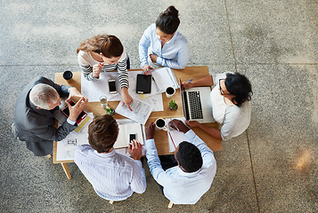 Image showing Top view, business people and group brainstorming, planning and creativity with documents, laptop or development. Staff, team or coworkers with collaboration, discussion or share ideas with paperwork