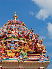 Image showing Hindu temple, Sri Mariamman and blue sky of history, culture and religion architecture in Singapore. Background, indian faith and worship, prayer or spiritual sign of building design, art and roof