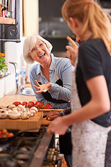 Image showing Woman, grandmother and cooking together in kitchen or teach recipe, prepare dinner or cook lunch with family. Senior mother, girl and conversation in home or talking about food or healthy vegetables