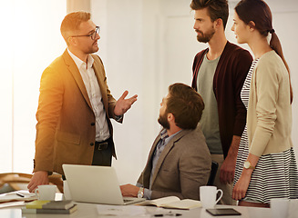 Image showing Meeting, leadership and training with a manager talking to his team in the office for upskill training. Planning, strategy and collaboration with a business man teaching his employee staff at work