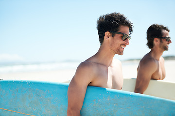 Image showing Beach, summer and man surfer friends bonding outdoor on vacation or holiday travel overseas. Surf, sea or fun with a happy young male and friend in sunglasses surfing together on an ocean coast