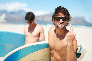 Image showing Beach, middle finger and man surfing friends outdoor together for summer vacation or holiday trip overseas. Surf, sea or rude with a young male surfer in sunglasses and friend bonding at the coast