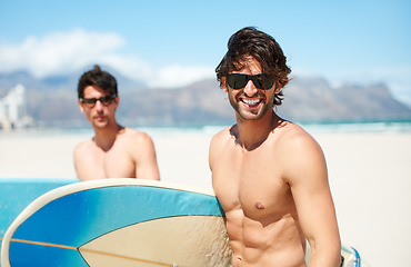 Image showing Beach, sea and man surfing friends outdoor together for travel, vacation or holiday trip overseas. Surf, summer or fun with a young male surfer in sunglasses and friend bonding on an ocean coast