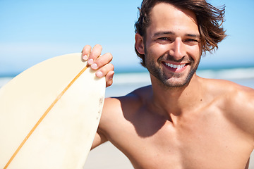 Image showing Portrait, surfing and a man in the ocean at the beach for surfing while on summer holiday or vacation. Invite, come and join with a happy young male surfer holding a surfboard outdoor by the sea