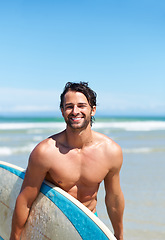 Image showing Portrait, surfboard and a man laughing at the beach in the ocean while surfing on summer vacation or holiday. Smile, body or fun with a happy young male surfer shirtless outdoor by the sea for a surf