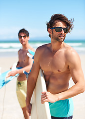 Image showing Beach, summer and man surfer friends outdoor together for travel, vacation or holiday trip overseas. Surf, sea or fun with a young male and friend surfing in sunglasses bonding on an ocean coast