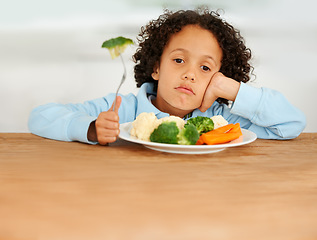 Image showing Bored, upset and child eating vegetables for a healthy, growth and wellness diet at his home. Nutrition, dinner and sad boy kid at the dining table with produce lunch, snack or meal at his house.