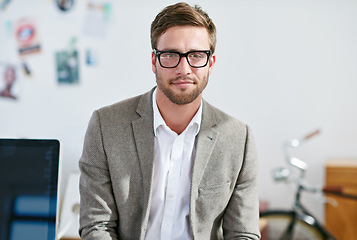 Image showing Portrait, eyewear and focus with a business man in the office for corporate or professional work. Face, glasses and leadership with a young male manager or leader at work on a blurred background