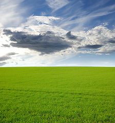 Image showing Nature, clouds and hill with landscape of field for farm mockup space, environment and ecology. Plant, grass and horizon with countryside meadow for spring, agriculture and sustainability