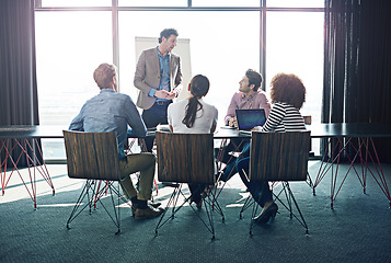 Image showing Meeting, presentation and business with a man CEO in the boardroom for training, coaching or education. Workshop, management or leadership with a mature male employee talking to his team in an office