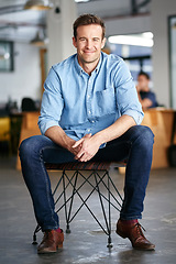 Image showing Happy, confidence and portrait of a man in a office sitting on a chair with success, vision and ambition. Happiness, smile and professional male entrepreneur with startup business in modern workplace