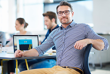 Image showing Smile, desk and portrait of a businessman at work for web design, creativity or expert at an agency. Happy, creative and a mature designer with a laptop for a website, email or graphic professional