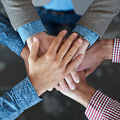 Image showing Top view, collaboration and hands together for teamwork, team building or solidarity. Cooperation, hand huddle and group of people with motivation, trust or support for community goals in partnership