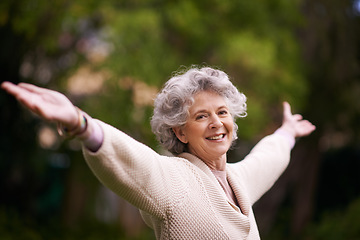 Image showing Portrait, happiness and senior woman with open arms in backyard garden or lady with a happy smile on face, celebrate life. Healthy, smiling pensioner stretching with freedom and success in retirement