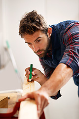 Image showing Man, wood and pencil for measure for construction, home development and building renovation. Carpenter, maintenance employee and male repairman worker on a contractor job of builder working in house