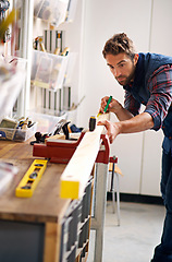 Image showing Worker man, wood and tape measure for construction, home development and building renovation. Carpenter, maintenance employee and male repairman on a contractor job of builder working in house