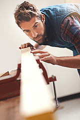 Image showing Carpenter, wood and design with man in workshop for building, manufacturing and creative. Planning, industry and woodworker with handyman measuring on workbench for builder, lumber and maintenance