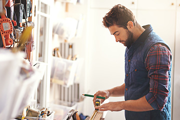 Image showing Carpenter, wood and measure with man in workshop for building, manufacturing and creative. Planning, industry and woodworker with handyman measuring on workbench for builder, lumber and maintenance