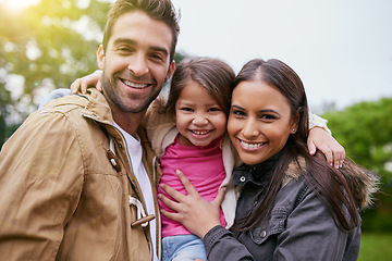 Image showing Family, happy hug and park portrait with a mom, dad and girl together with happiness and smile. Outdoor, face and vacation of a mother, father and young kid with bonding, parent love and child care