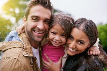 Image showing Family, closeup and park hug portrait with a mom, dad and girl together with happiness and smile. Outdoor, face and vacation of mother, father and kid with bonding, love and child care in nature