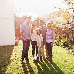 Image showing Hug, outdoor portrait and happy family grandparents, parents and child bonding, smile and together in backyard lawn. Happiness, solidarity and reunion people enjoy summer sunshine, love and support