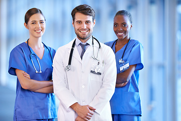 Image showing Medical, collaboration and portrait of doctor with nurses standing in a corridor of the hospital. Confidence, diversity and team of happy professional healthcare workers with smile in medicare clinic