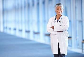 Image showing Portrait, healthcare and arms crossed with a senior doctor standing in a hospital corridor for research or insurance. Medical, trust and technology with a woman medicine professional in a clinic